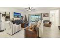 Spacious living room with a comfortable sofa, armchair, and a large TV at 439 Annabelle Way, Davenport, FL 33837