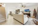 Open-concept living room with a view of the kitchen and stairs at 439 Annabelle Way, Davenport, FL 33837