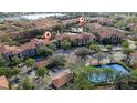Aerial view of community pool, tennis courts, and buildings at 6141 Metrowest Blvd # 307, Orlando, FL 32835