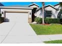 One-story house with a white garage door and a red front door at 1569 Thetford Cir, Orlando, FL 32824