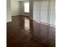 Living room with dark wood laminate flooring and access to a patio at 4119 Dijon Dr # 4119H, Orlando, FL 32808