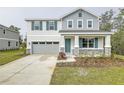 Two-story house with gray siding, teal shutters, and stone accents at 680 Summit River Dr, Apopka, FL 32712