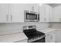 Stainless steel range and microwave in a modern kitchen at 680 Summit River Dr, Apopka, FL 32712