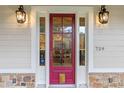 Charming red front door with sidelights, enhancing the home's curb appeal at 729 Main Street, Windermere, FL 34786