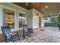 Relaxing front porch with rocking chairs and a view of the landscaped yard at 729 Main Street, Windermere, FL 34786