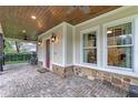 Inviting front porch with brick pavers, ceiling fan, and rocking chairs at 729 Main Street, Windermere, FL 34786