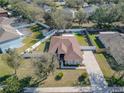 Aerial view showing a house with a fenced backyard and driveway at 1032 Tawny Eagle Dr, Groveland, FL 34736