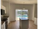 Kitchen with island, stainless steel appliances, and view of pool at 14716 Yorkshire Run Dr, Orlando, FL 32828