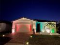 Attractive one-story home with colorful nighttime lighting and landscaping at 161 Andreas St, Winter Haven, FL 33881