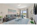 Relaxing living room with comfortable couch and access to balcony at 3151 Paradox Cir # 201, Kissimmee, FL 34746
