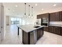 Modern kitchen with island, stainless steel appliances and breakfast bar at 9778 Bucklow Hill Dr, Orlando, FL 32832