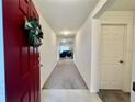 Bright and airy entryway with tile flooring and views into the living room at 119 Summerlin Loop, Haines City, FL 33844