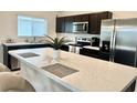 Modern kitchen with stainless steel appliances and an island at 119 Summerlin Loop, Haines City, FL 33844