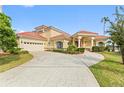 Grand two-story home with red tile roof and attached garage at 2789 Kissimmee Bay Cir, Kissimmee, FL 34744