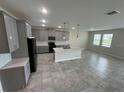 Modern kitchen with gray cabinets and a large island at 2949 Nottel Dr, Saint Cloud, FL 34772