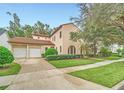 Two-story house with tile roof, double garage, and lush landscaping at 1233 Aquila Loop, Celebration, FL 34747