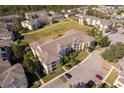 Apartment building with parking and green space, seen from above at 2302 Butterfly Palm Way # 303, Kissimmee, FL 34747