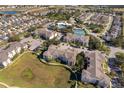 Community overview showing apartment buildings, pools, and tennis courts at 2302 Butterfly Palm Way # 303, Kissimmee, FL 34747