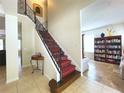 View of the staircase with ornate railing and runner at 2603 Isla Bonita Ct, Kissimmee, FL 34747