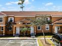 Front view of townhouse with parking and landscaping at 2618 Bugatti Ct, Kissimmee, FL 34746