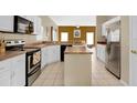 Spacious kitchen with island, stainless steel appliances, and white cabinets at 4603 Cumbrian Lakes Dr, Kissimmee, FL 34746