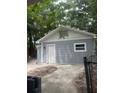 Gray detached garage with white door and window at 5413 Vanderlin St, Orlando, FL 32810
