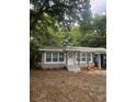 Newly renovated home with gray siding, landscaping, and a carport at 5413 Vanderlin St, Orlando, FL 32810
