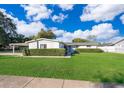 White single story home with a manicured lawn, updated landscaping and carport at 5804 Defiance Ave, Orlando, FL 32839