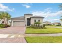 One-story home with a two-car garage and nicely manicured lawn at 1880 Goblet Cove St, Kissimmee, FL 34746