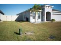 Landscaped side yard with a white fence at 2560 Bittle Way St, Saint Cloud, FL 34769