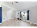 Living area with wood-look floors and a view of the front yard at 557 Dove Ct, Kissimmee, FL 34759