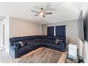 Living room features a large sectional sofa and a ceiling fan at 557 Dove Ct, Kissimmee, FL 34759