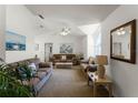 Spacious living room with vaulted ceilings, neutral decor, and ample natural light at 607 Tamarin Ln, Kissimmee, FL 34759