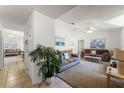 Bright living room with vaulted ceilings, neutral carpeting, and comfy sofas at 607 Tamarin Ln, Kissimmee, FL 34759