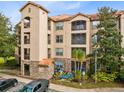 Attractive three story building with balconies and palm trees at 1301 Tuscan Ter # 9107, Davenport, FL 33896