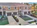 Aerial view of townhouses with brown garages and surrounding landscape at 1336 Chelsea Dr, Davenport, FL 33897
