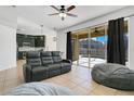 Living room with sliding glass doors to the backyard pool and a view into the kitchen at 3571 Maple Ridge Loop, Kissimmee, FL 34741