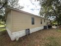Side view of mobile home showing exterior condition at 4914 Dove Ln, Auburndale, FL 33823