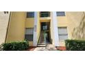 Condo building entrance with stairs and landscaping at 8910 Legacy Ct # 206, Kissimmee, FL 34747