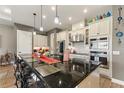 Modern kitchen with granite countertops, custom cabinetry, and island seating at 972 Ladera Ranch Rd, Kissimmee, FL 34759