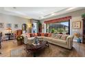 Bright living room with large windows, ample seating, and decorative accents at 972 Ladera Ranch Rd, Kissimmee, FL 34759