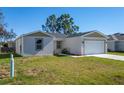Newly built home with a two-car garage and well-maintained lawn at 1603 Tench Ct, Kissimmee, FL 34759