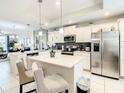 Modern kitchen with white cabinets and stainless steel appliances at 4741 Clock Tower Dr # 205, Kissimmee, FL 34746