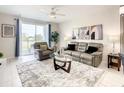 Relaxing living room featuring a comfy sofa and sliding doors at 4741 Clock Tower Dr # 205, Kissimmee, FL 34746