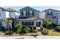 Two-story house with gray siding, landscaping, and a walkway at 12749 Brodlove Lane, Winter Garden, FL 34787