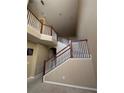 Two-story home interior with open staircase and high ceilings at 2018 Gold Spring Cv, Kissimmee, FL 34743