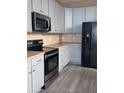 Modern kitchen with light gray cabinets and stainless steel appliances at 2018 Gold Spring Cv, Kissimmee, FL 34743