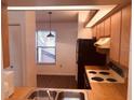 View of condo kitchen with appliances and wood cabinets at 3036 S Semoran Blvd # S, Orlando, FL 32822