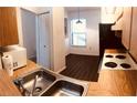Condo kitchen features wood cabinets and laminate flooring at 3036 S Semoran Blvd # S, Orlando, FL 32822