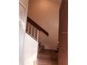 Carpeted stairway with simple railing leading to upper level at 3036 S Semoran Blvd # S, Orlando, FL 32822
